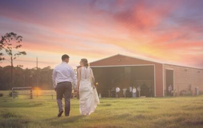 Bride and groom walking into the sunset at the Diamond L Venue in Volusia County, near Deltona, FL