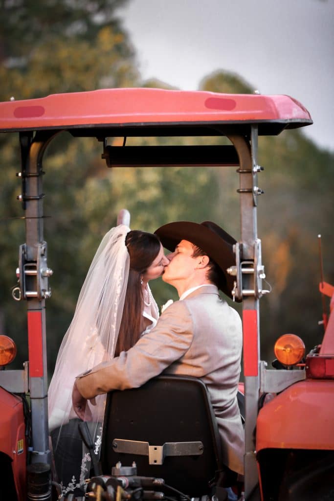 bride and groom kissing in tractor at the Diamond L Venue in Volusia County, near Deltona, FL