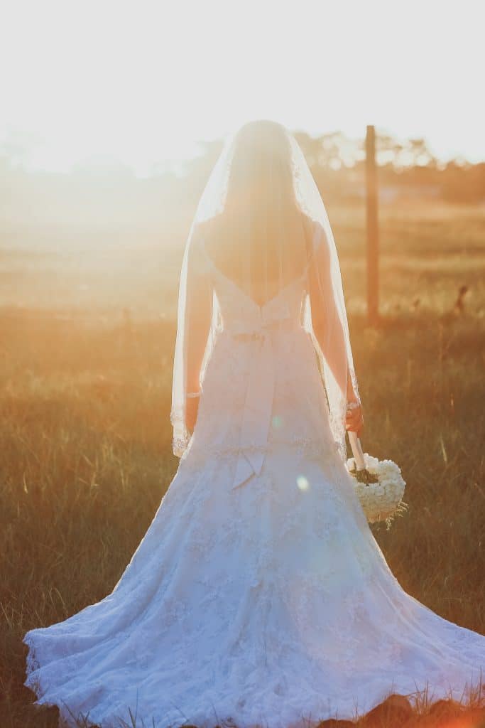 bride posing in field at sunset at the Diamond L Venue in Volusia County, near Deltona, FL