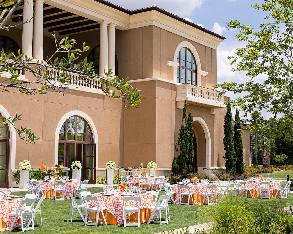 View of the outside lawn area, set up with round tables, peach tablecloths, Orlando