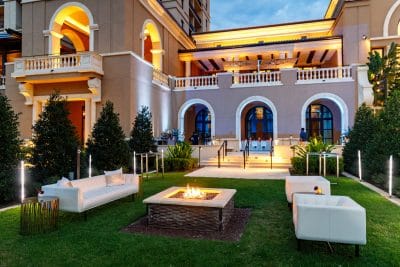 lawn area with firepit, comfortable sofas, at sunset, Orlando