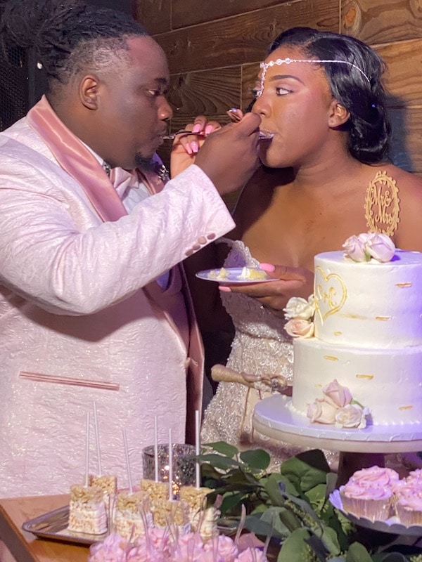 Hidden Barn bride and groom feeding each other cake