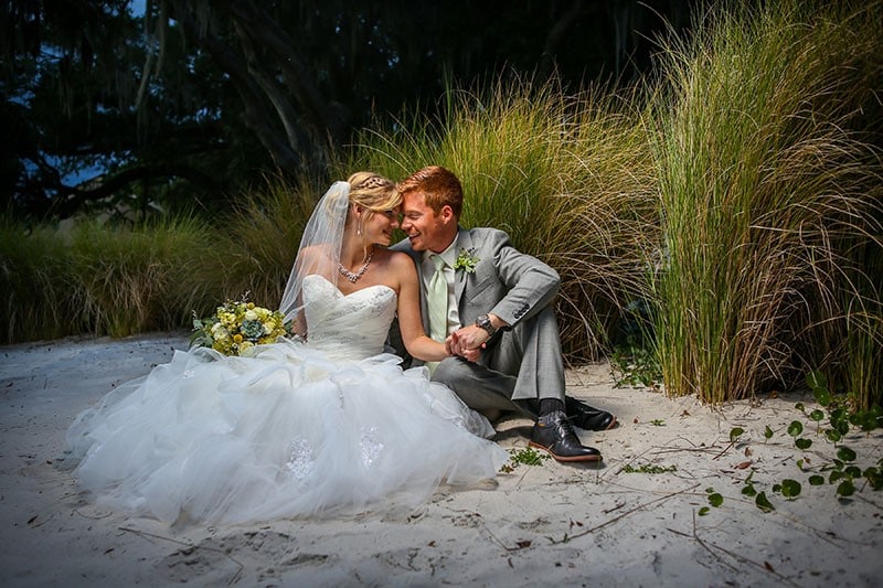 Lakeside-Inn- Couple sitting on private beach kissing