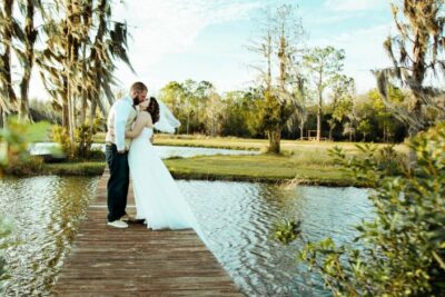 bride and groom on bride over lake in lake county wedding