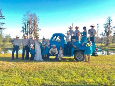 Mystical Winds blue pickup truck in field for country wedding