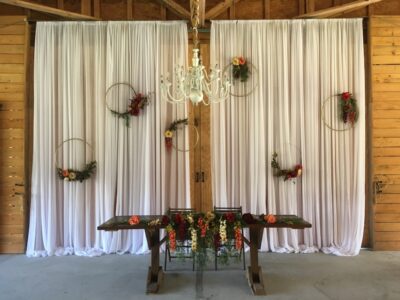 Mystical Winds wedding reception decorations with curtains and chandelier