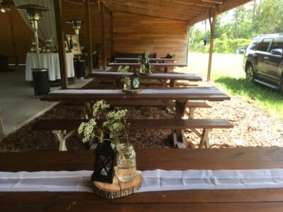 Mystical Winds outdoor tables under overhang with centerpieces