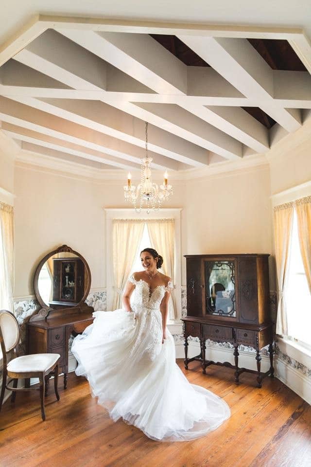 The-Highland-Manor-Bride dancing in bridal suite with wedding dress on