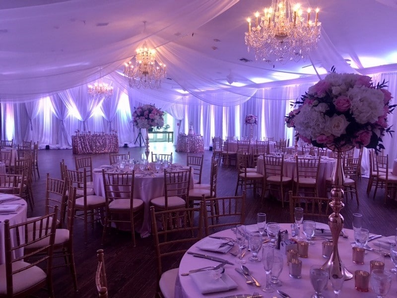 The-Highland-Manor-Interior of reception hall with tall floral centerpieces