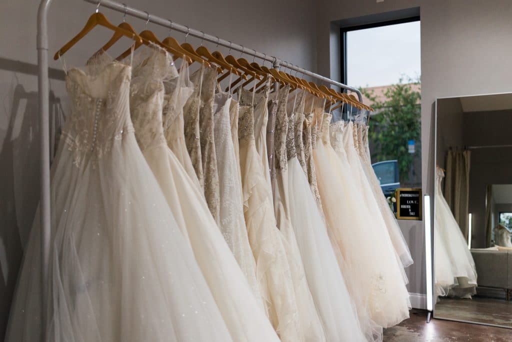 wedding dresses hanging on rack