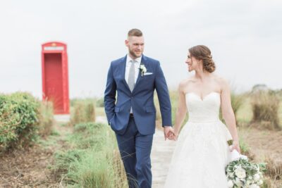 Birde and groom walking together, red phone booth in the background, The Royal Crest Room, Orlando, FL