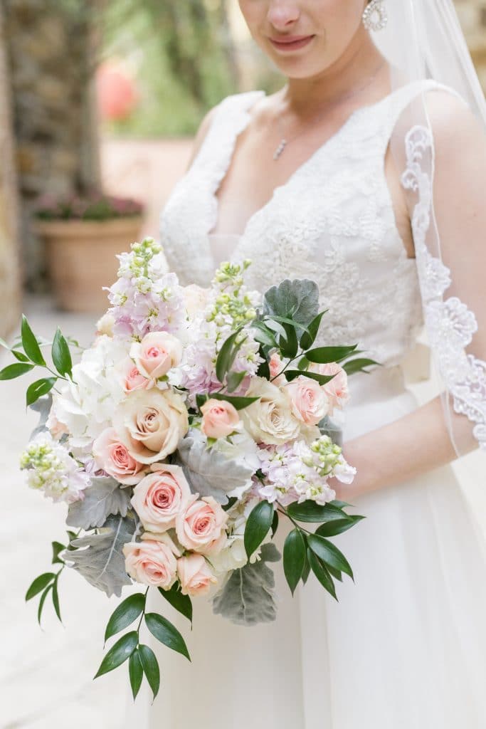 bride with pink roses in wedding bouquet
