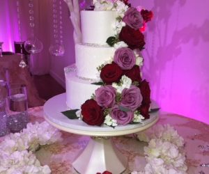 Cake Designers - 3-tiered cake with cascade of red and purple flowers