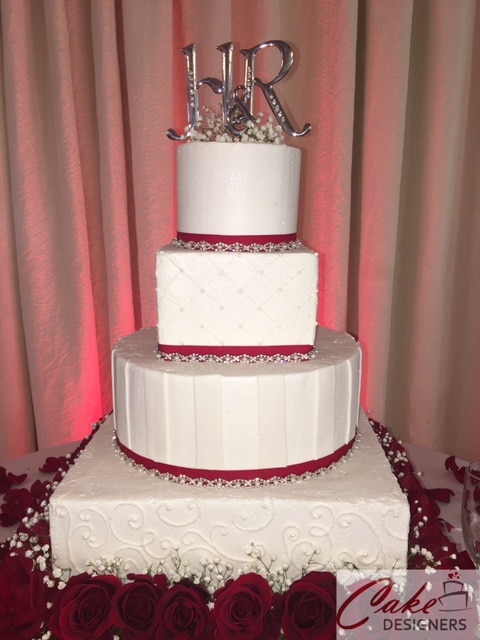 Cake Designers - clean, modern cake surrounded by red roses