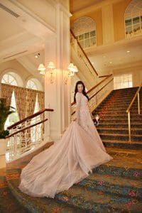 bride arranging her train on the grand staircase, Rhodes Studios, Orlando, FL