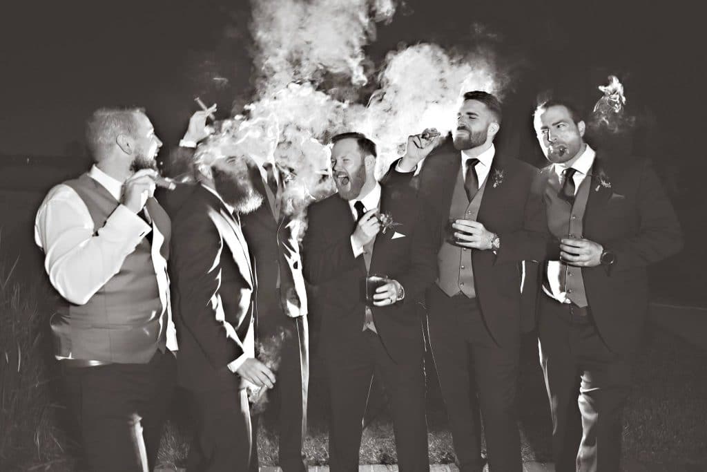 Rhodes Studios Photography and Video - groom and groomsmen laughing and smoking cigars