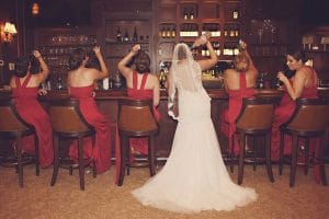 bride and bridesmaids having a drink at the bar, celebrating the wedding, Orlando, FL