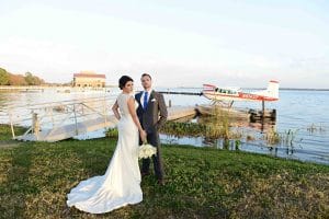 Rhodes Studios, photography and Video, bride and groom posing next to seaplane, Orlando, FL
