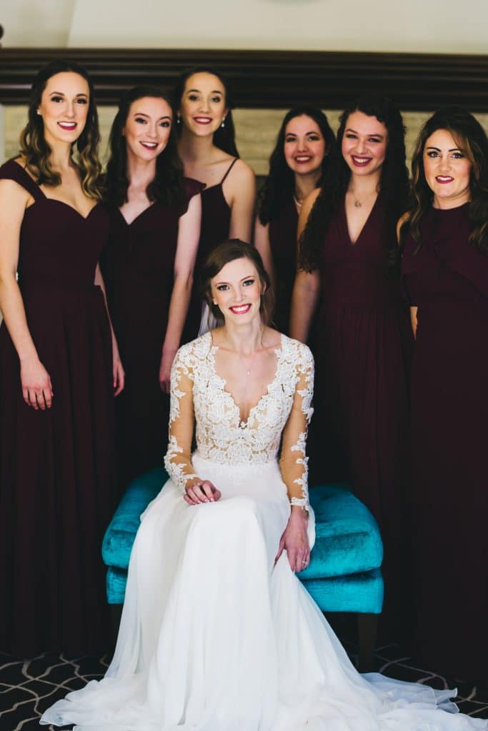 Rudy & Marta Photography - bride surrounded by bridesmaids in burgundy