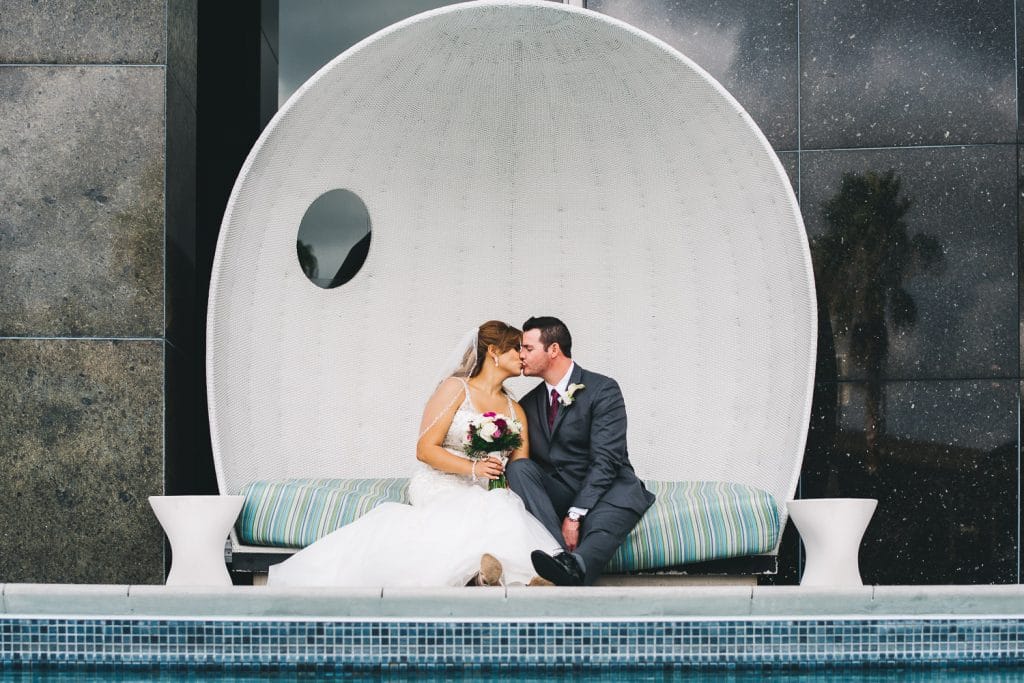 Rudy & Marta Photography - bride and groom kissing inside futuristic sphere seat