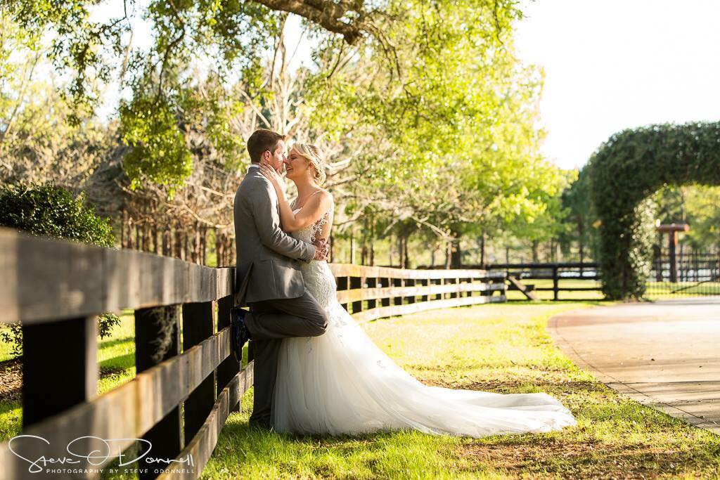 Club Lake Plantation - bride and groom beside fence