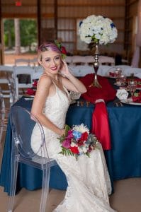 Blue View Event Barn - bride poses at reception table in clear chair