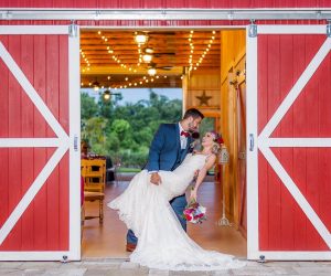 Blue View Event Barn - groom dipping bride in barn doorway