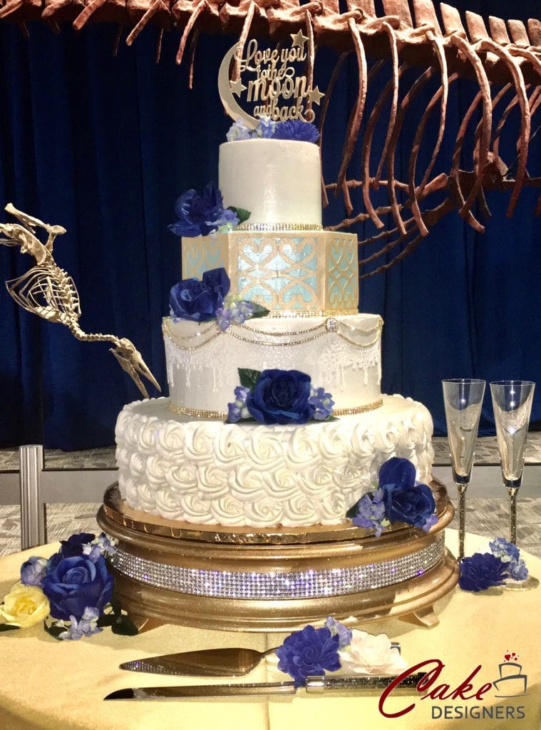 4 tier white cake with blue flowers