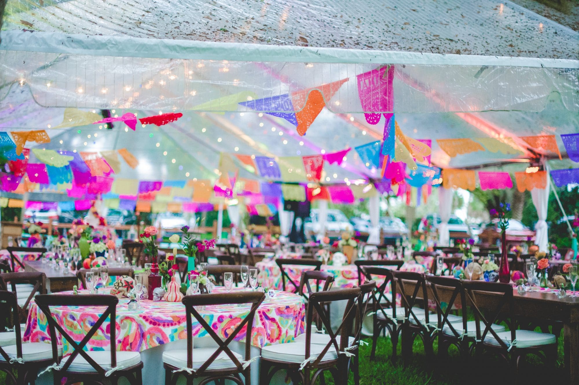 wedding reception tent with colorful papel picado garland