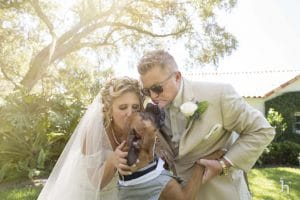 FairyTail Pet Care - bride and groom kissing dog