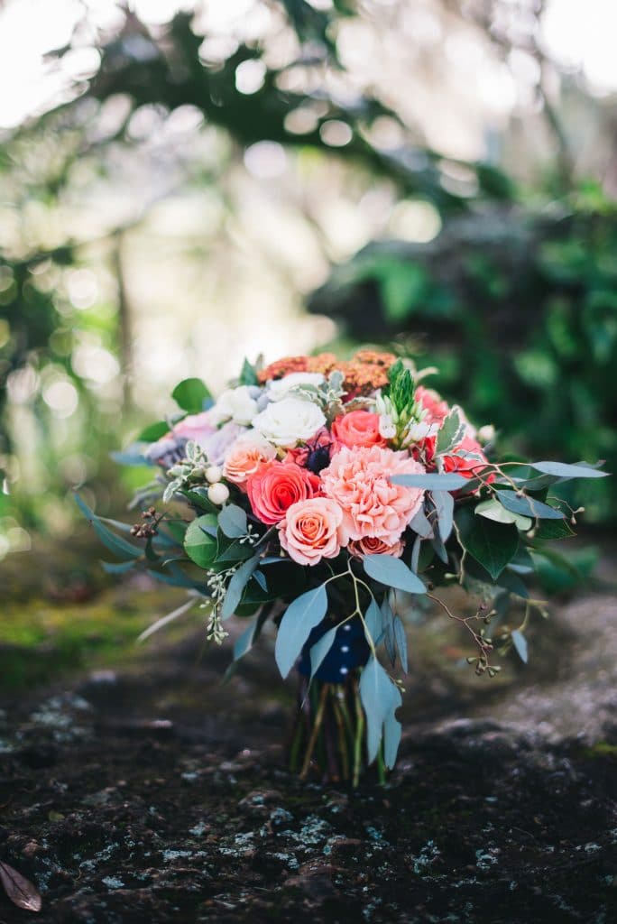 The Flower Studio - loose, romantic bouquet in shades of orange, sherbert and cream in greenery