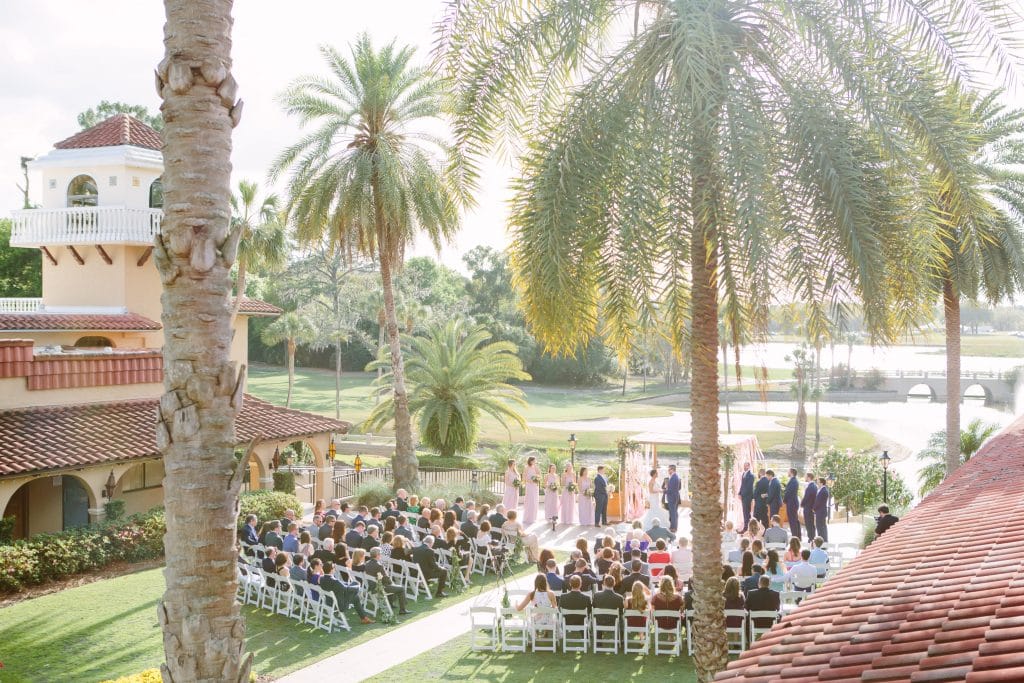 Orlando Wedding Photographer - KMD Creations photo of wedding ceremony with tower and lake in the background