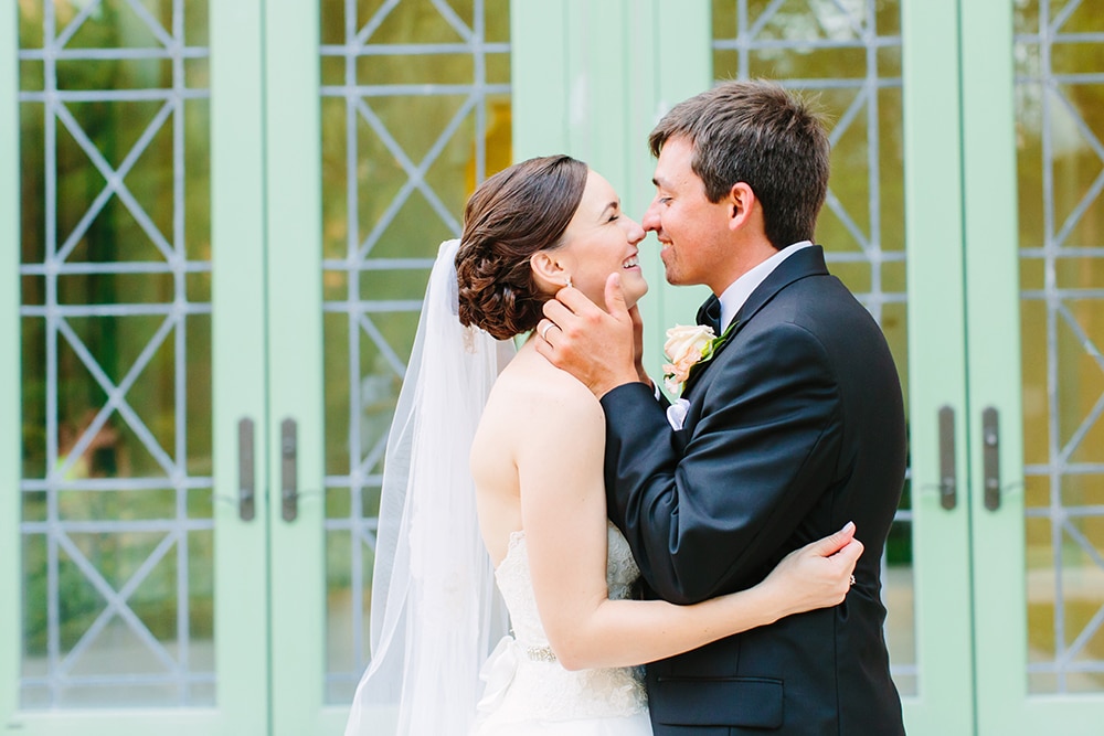 photo of groom holding brides face getting ready to kiss her by KMD Creations