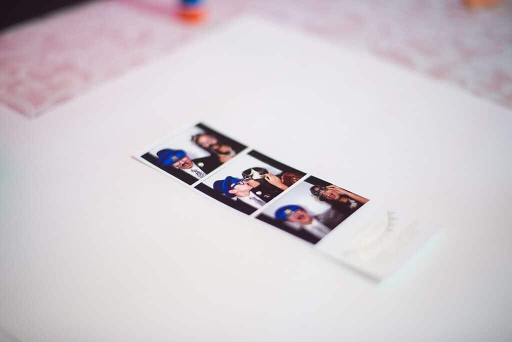photo booth strip on table - History of Photo Booths photo booth strip on table