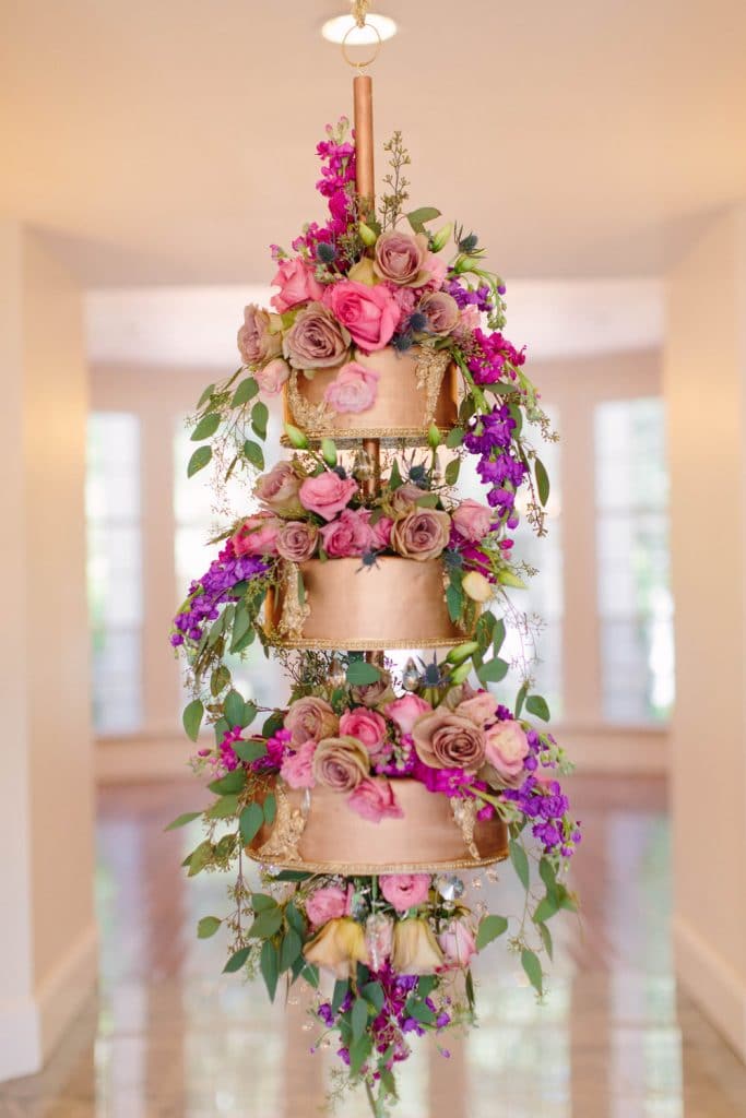 Atmospheres Floral - gold tiered cake with purple flowers