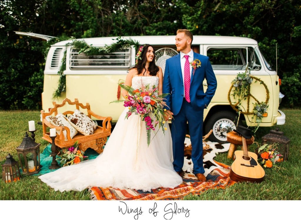 Atmospheres Floral - bride with colorful bouquet and groom next to VW van surrounded with trinkets