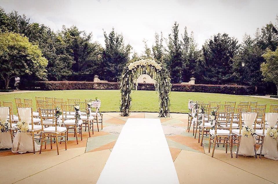 Atmospheres Floral shows wedding ceremony arch covered in greenery and hanging flowers
