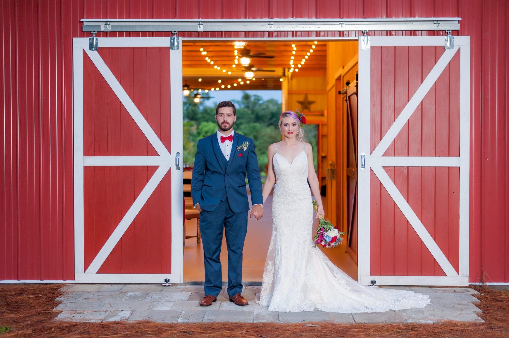 Blue View Event Barn - newlyweds holding hands in doorway of barn