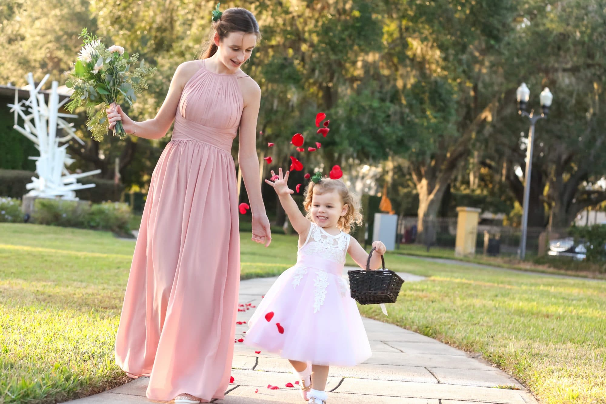 bridesmaid and flower girl walking down aisle