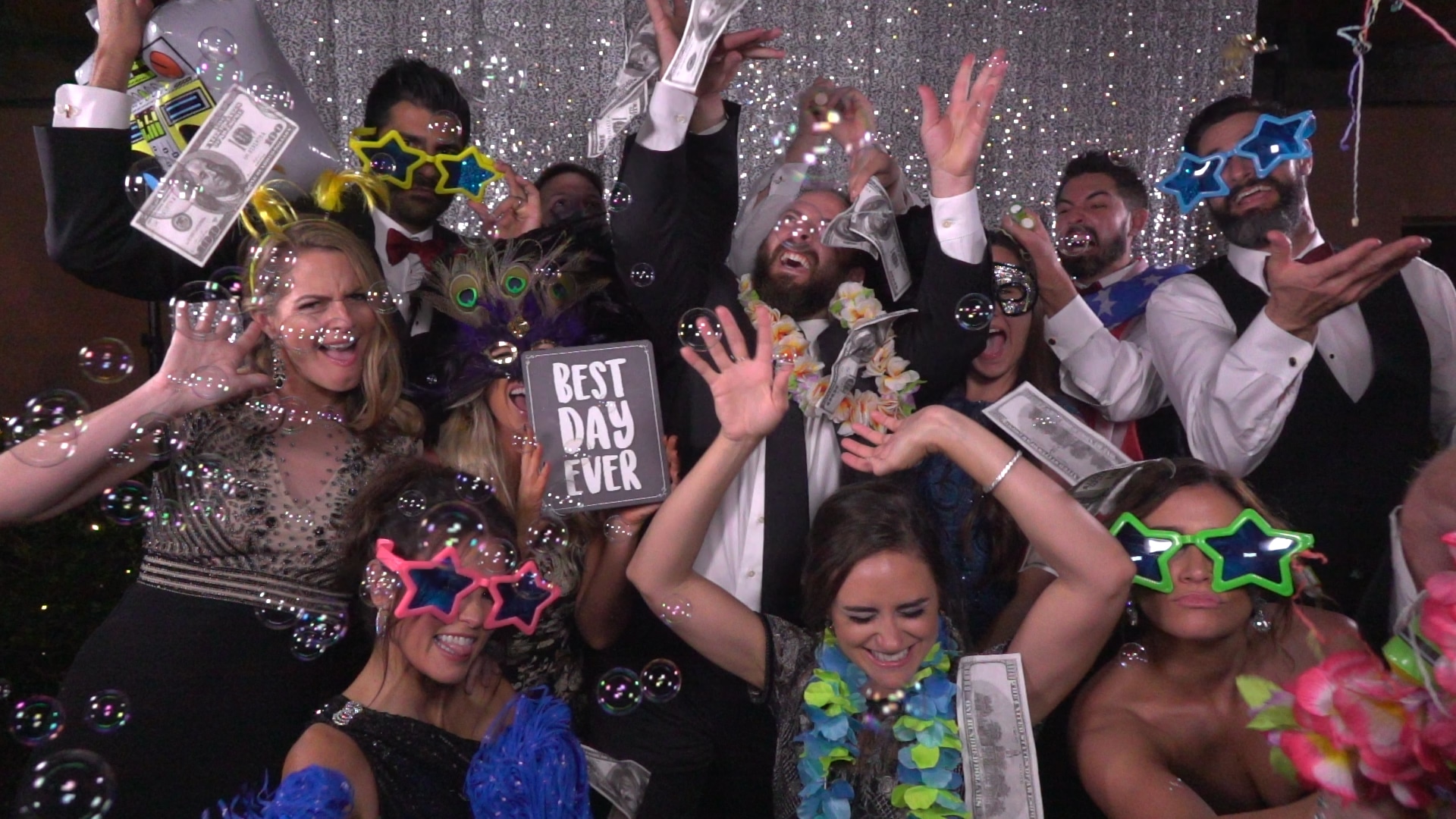 Omarvelous Productions - guests celebrating in photo booth with bubbles