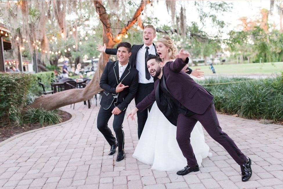 Singers Dan and Shay posing with excited bride and groom