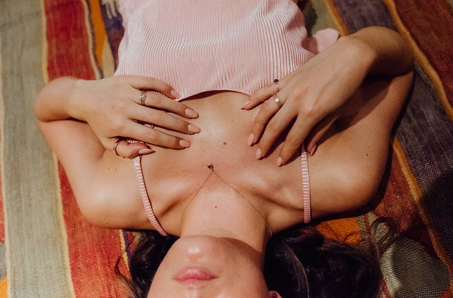 woman laying on ground wearing jewelry
