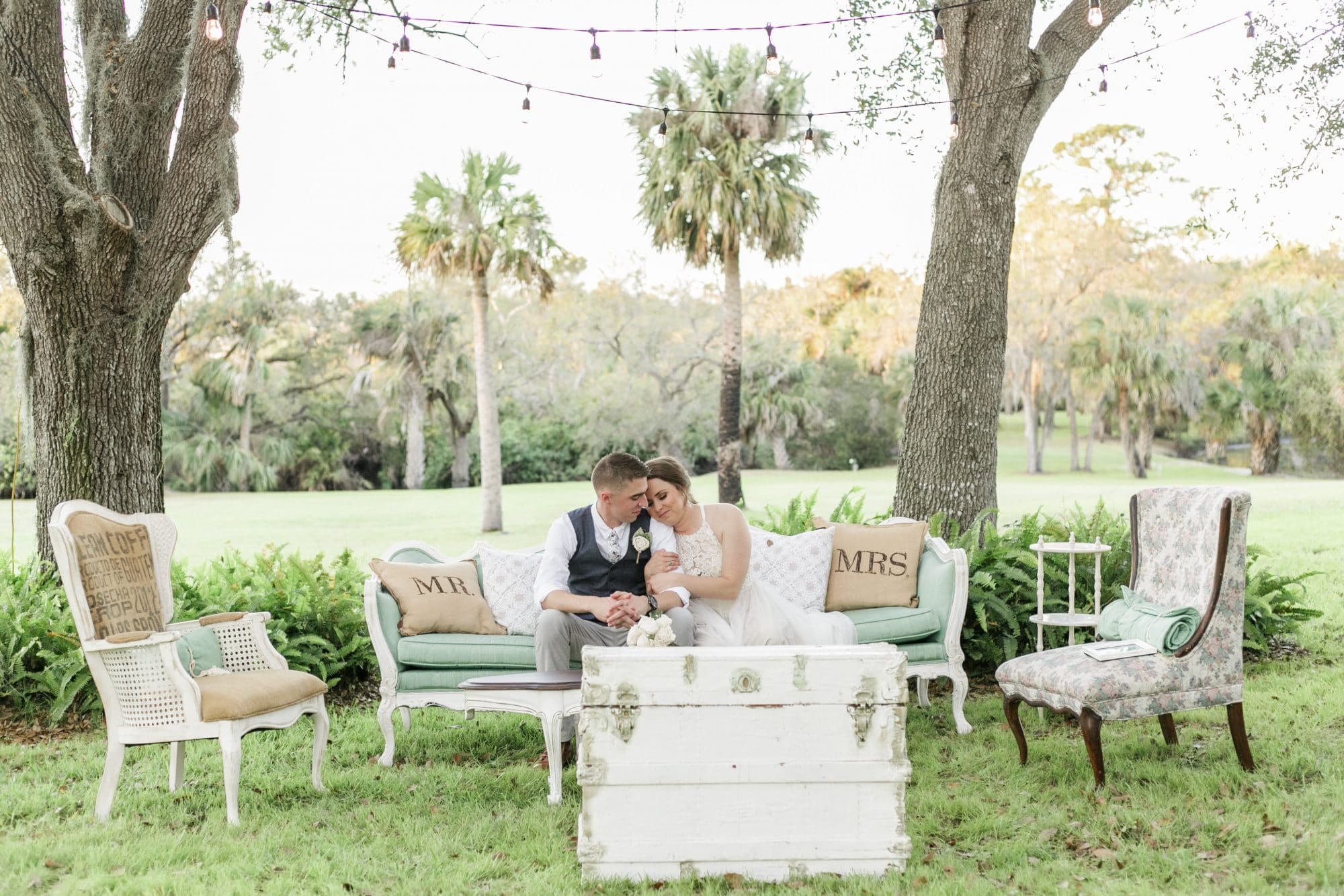 bride and groom nestled on outdoor couch