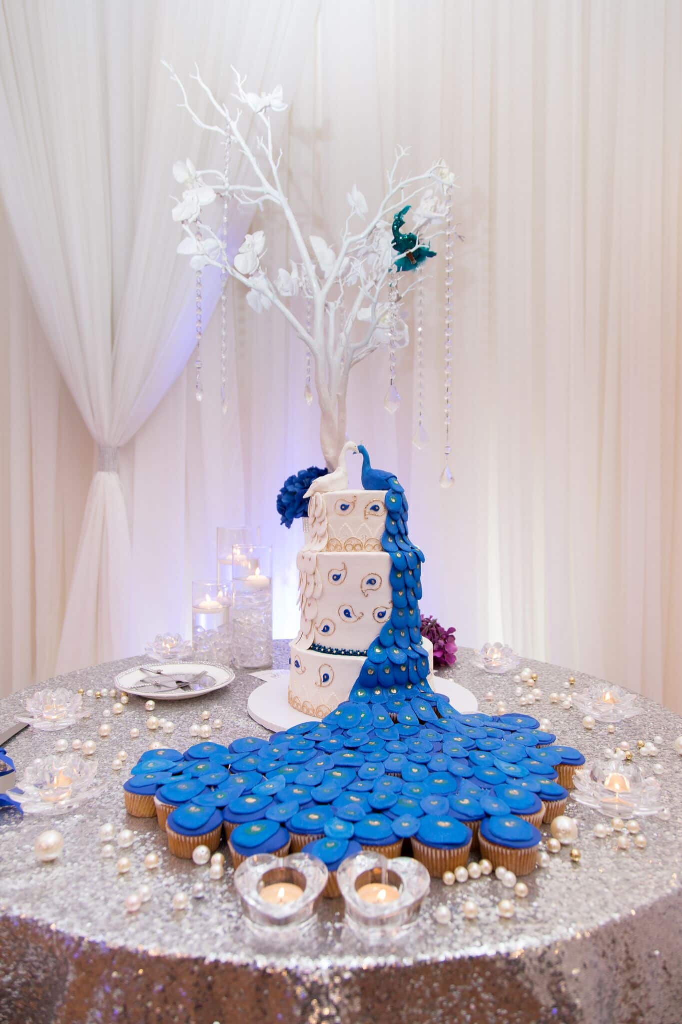 Wedding Cake FAQs - peacock wedding cake with cupcake tail