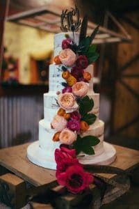 Everything Cake - semi naked cake with cascade of bold blooms
