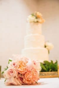 Everything Cake - pale pink bouquet in foreground with simple white cake