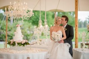 Everything Cake - bride and groom posing near simple, sweet, pink and white cake