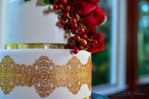 Everything Cake - cake closeup of gold lace accents and red berries and roses