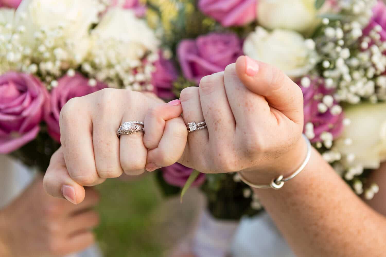 Lori Barbely Photography, closeup of two brides showing wedding rings 