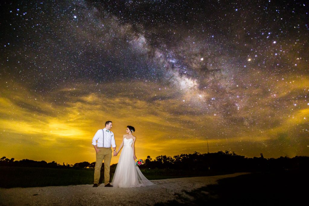 Steven Miller Photography - bride and groom with Milky Way night sky in background